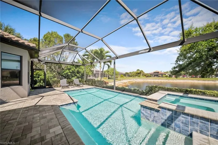 Integrated pool / spa featuring a patio, a sunroom, a lanai, and a water view