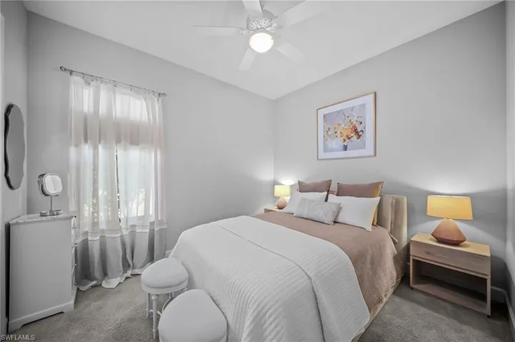 Carpeted bedroom featuring a ceiling fan