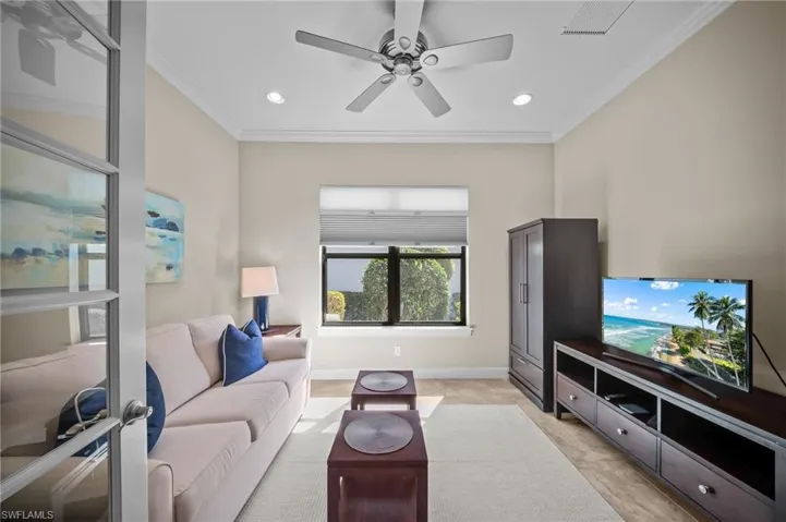 Living room with a ceiling fan, crown molding, and recessed lighting