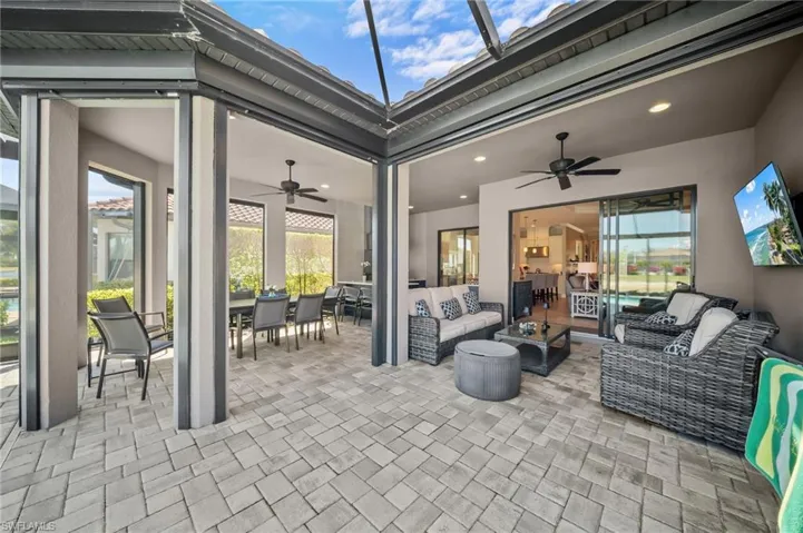 View of patio with outdoor lounge area, ceiling fan, and a sunroom