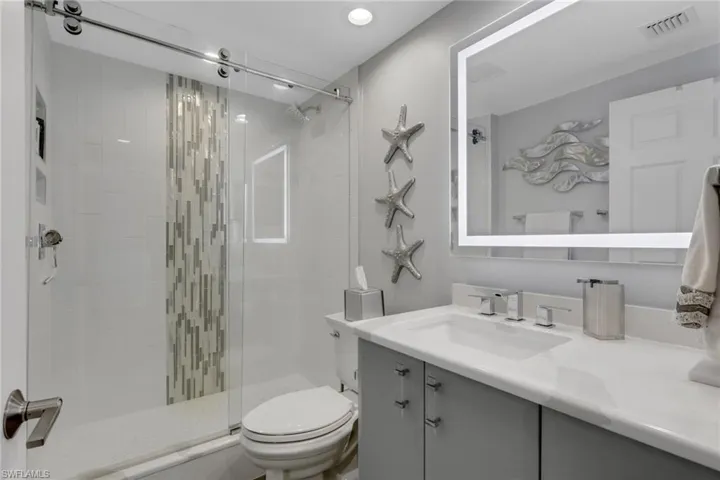 Full bath featuring vanity and a stall shower