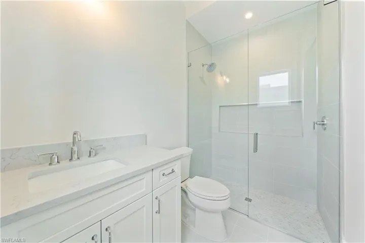 Bathroom 2 is light and bright with white shaker cabinetry and bright quartz. A 40x40 mirror will be installed upon delivery.
