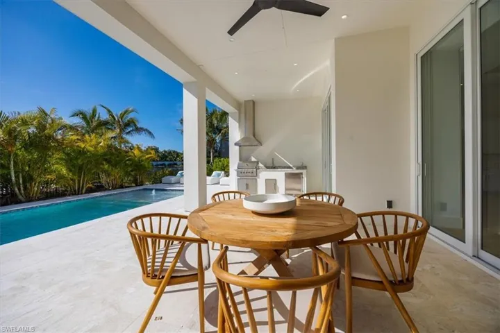 Shellstone pool deck with covered and uncovered living, natural gas fireplace, and natural gas outdoor kitchen