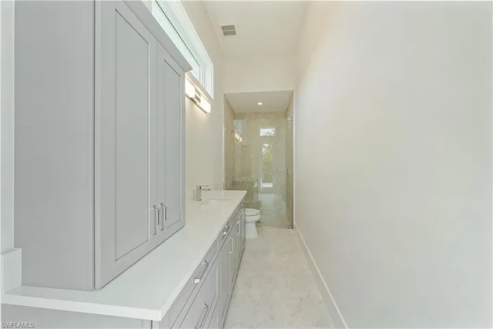 The Jr. Primary bath (bath 4) features ample storage and direct access to the pool deck.