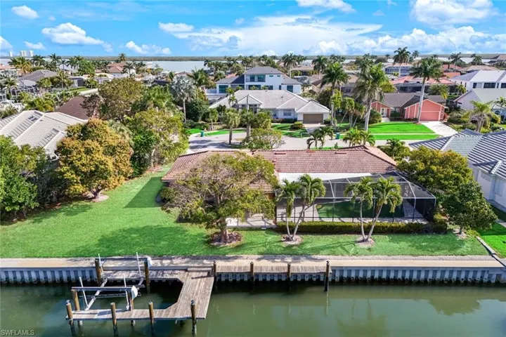 Aerial perspective of suburban area featuring a large body of water
