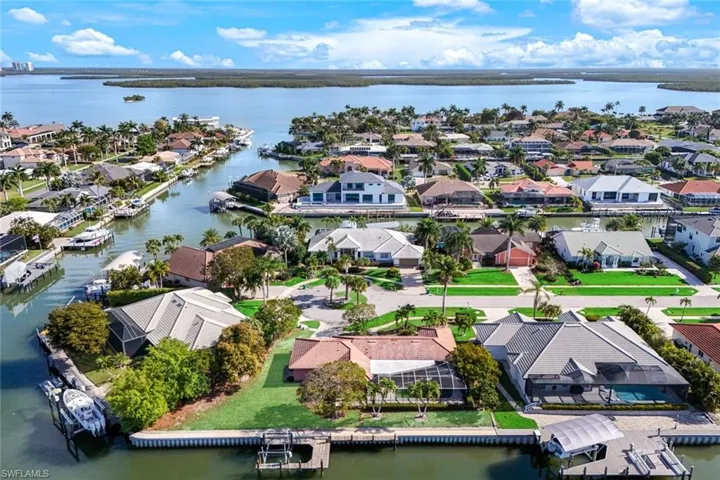 Aerial perspective of suburban area featuring a large body of water