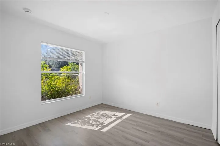 Unfurnished room with light wood finished floors and baseboards