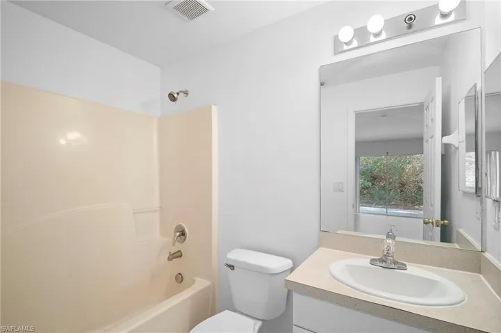 Full bath featuring vanity and bathing tub / shower combination