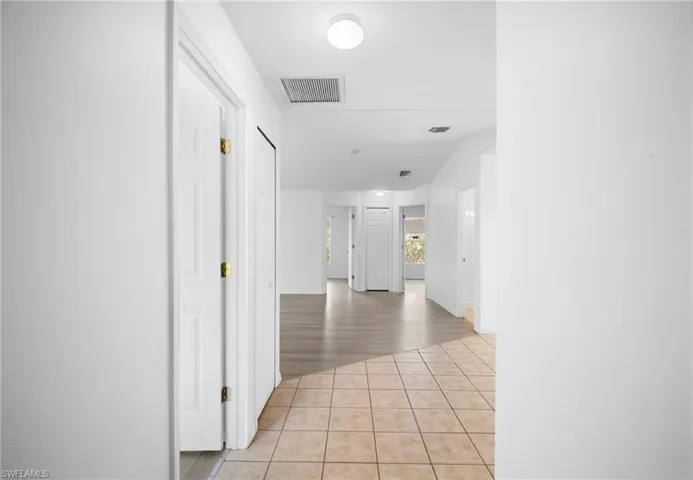Corridor featuring light tile patterned floors