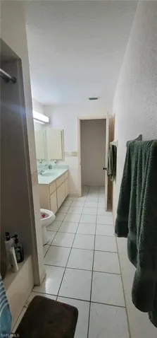 Bathroom with vanity and shower / bath combination with curtain
