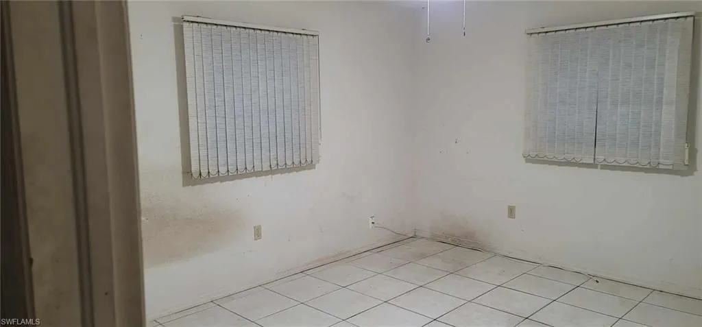 Empty room featuring light tile patterned floors