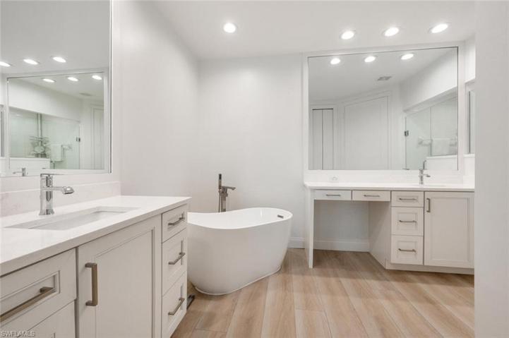 Beautiful Master Bathroom with Quartz Counter Tops, Custom Mirrors, Separate sink areas and walk in tile shower.