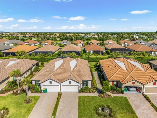 Expansive community of single-story residences featuring tile roofs and paver driveways