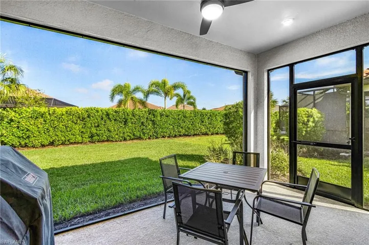 Screened patio featuring a ceiling fan, recessed lighting, and direct access to the backyard