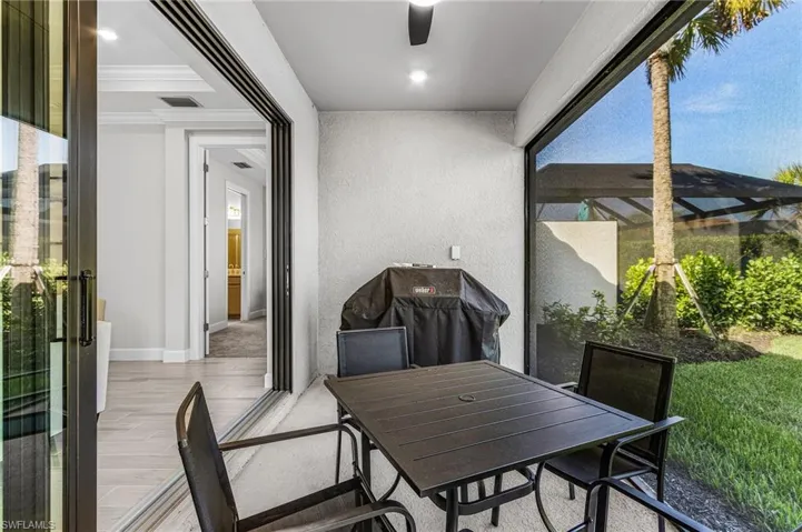 Covered patio featuring a ceiling fan, recessed lighting, and a screened enclosure