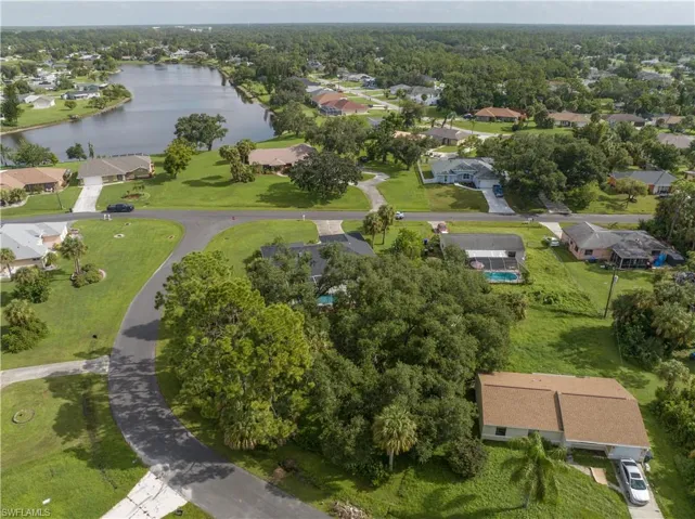 Birds eye view of property with a water view