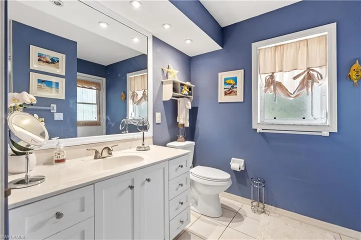 Bathroom featuring vanity, toilet, and tile patterned floors