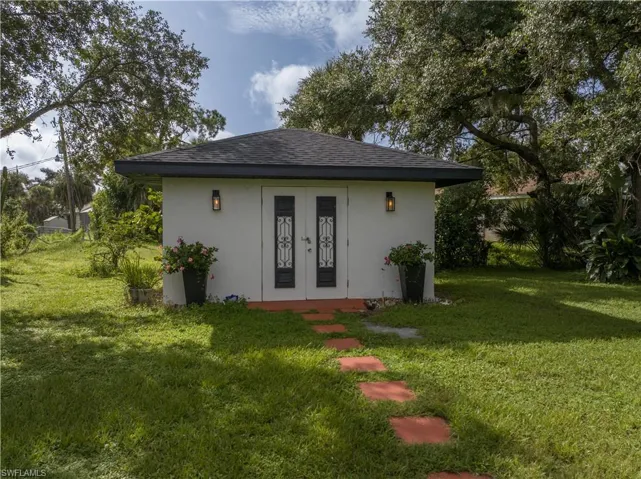 Rear view of property with a lawn
