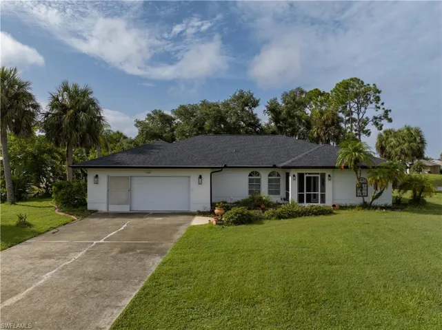 Ranch-style house with a garage and a front yard