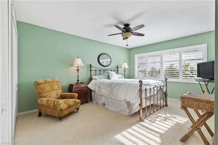 Carpeted bedroom with ceiling fan
