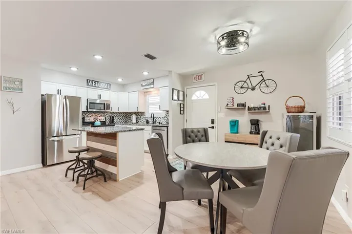 2nd Level Dining room with light wood finished floors and recessed lighting- Virtually Edited Image