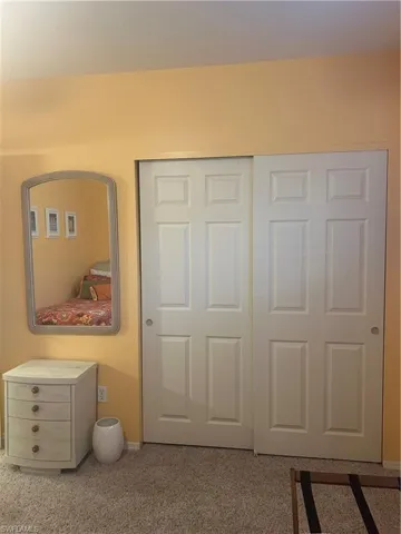 Guest Bedroom featuring carpet flooring and a closet