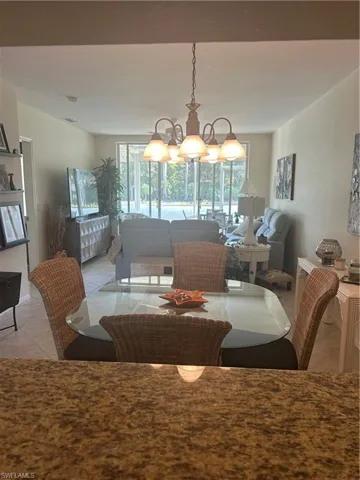 Dining space with light tile patterned flooring