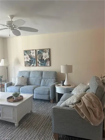 Comfortable living room featuring ceiling fan