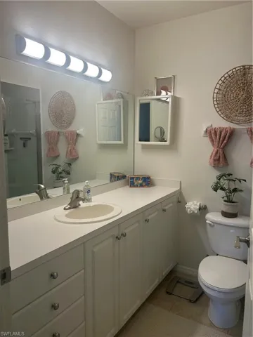 Primary Bathroom featuring large vanity and light tile patterned flooring