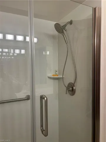 Primary Bathroom view of a shower stall with new shower doors and shower hardware.