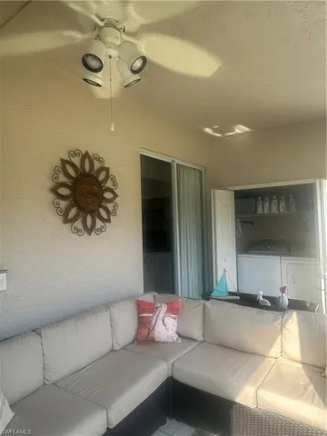 View of screened in lanai, outdoor living space and washing machine and clothes dryer