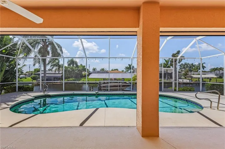 View of pool with a patio and a lanai