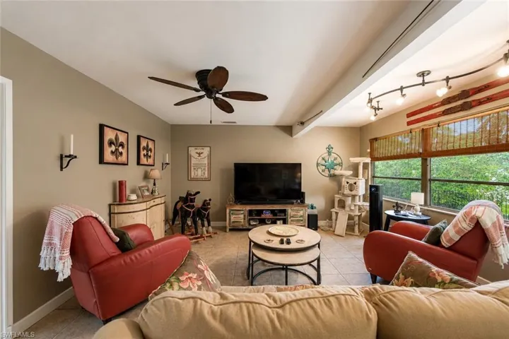 Spacious living area featuring neutral wall tones and tile flooring