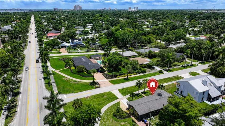 Aerial perspective showcasing a residential area with established landscaping and a distant cityscape