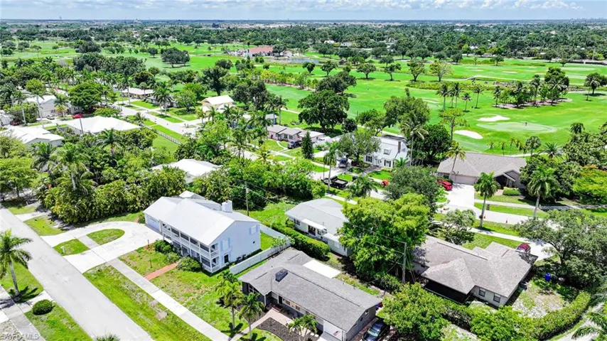 Expansive golf course with manicured greens and mature trees
