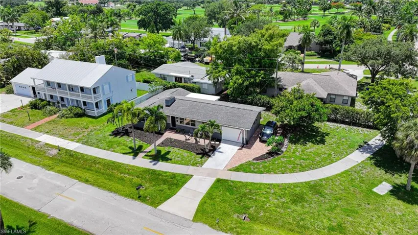 Single-story residence featuring a gray shingle roof, attached garage, and a brick paver driveway