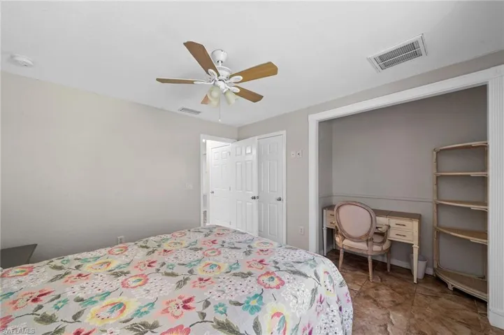 Bedroom with ceiling fan and baseboards