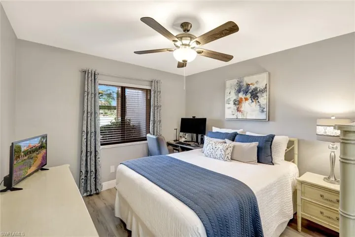 Bedroom with ceiling fan and hardwood / wood-style floors