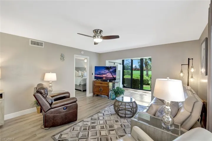 Living room featuring hardwood / wood-style flooring and ceiling fan