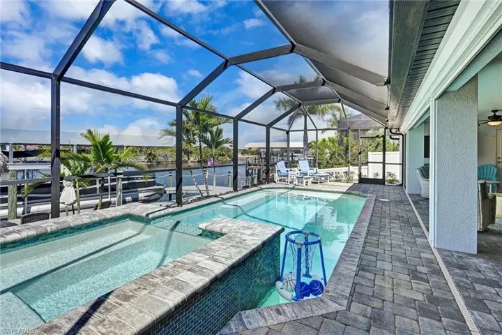 Enclosed pool and spa, triple sliding glass doors, and electric hurricane shutters
