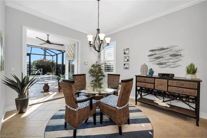 Sunny and bright breakfast room. French doors open to the pool area.