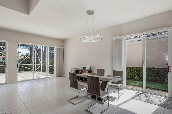 Dining area featuring baseboards, an inviting chandelier, and light tile patterned floors