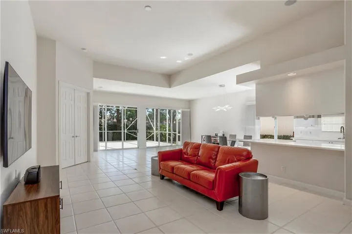 Living area featuring light tile patterned floors and recessed lighting