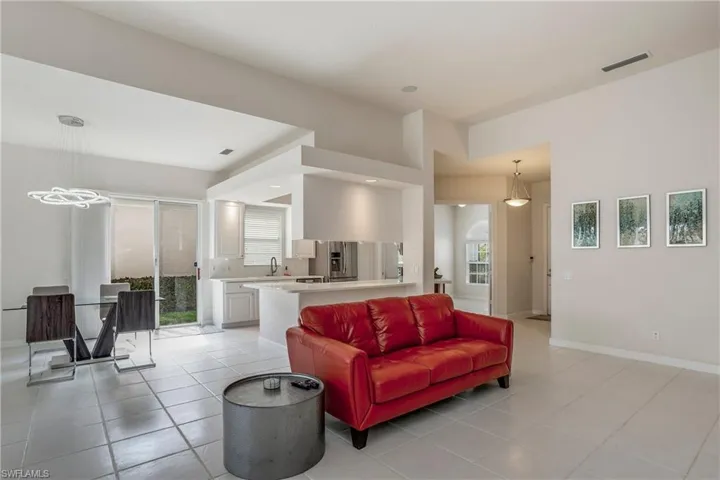 Living area with baseboards, visible vents, and light tile patterned floors