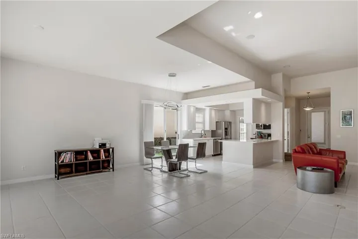 Living area with baseboards and light tile patterned floors