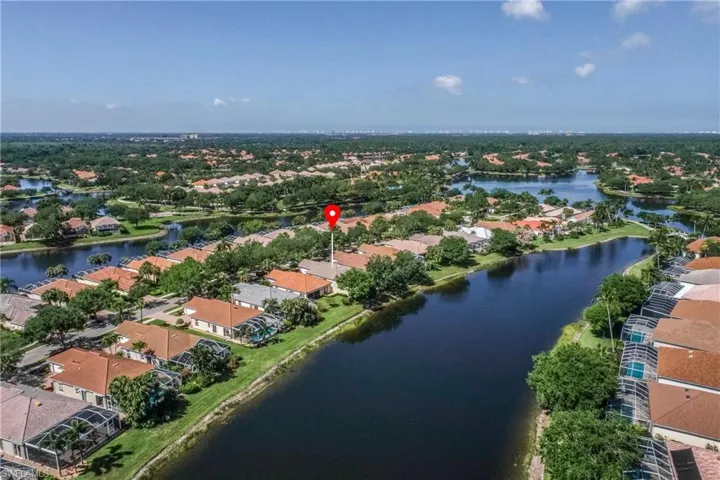 Birds eye view of property with a residential view and a water view