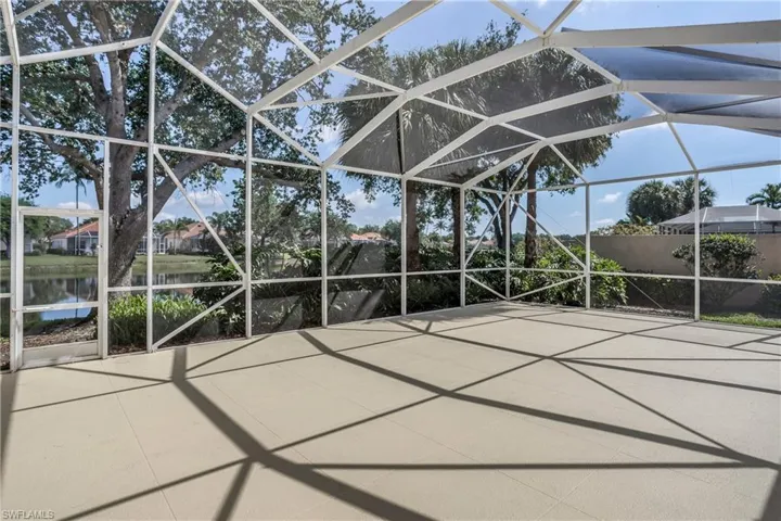 View of patio / terrace featuring a water view and a lanai