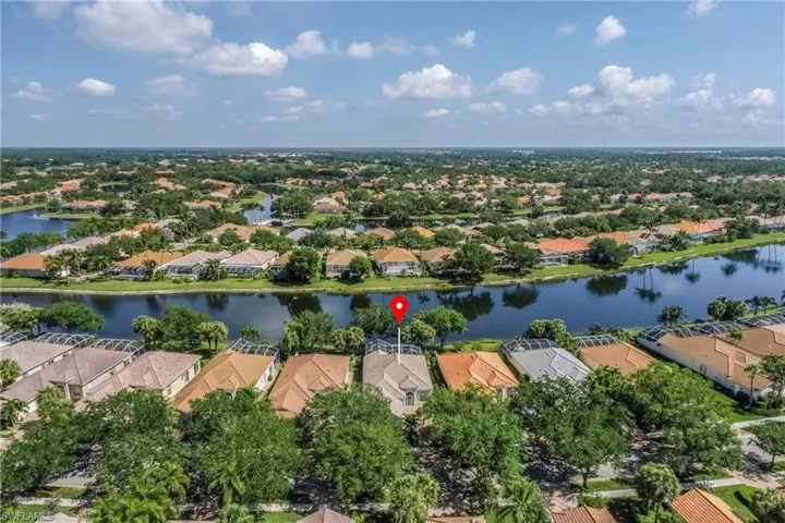 Birds eye view of property featuring a residential view and a water view