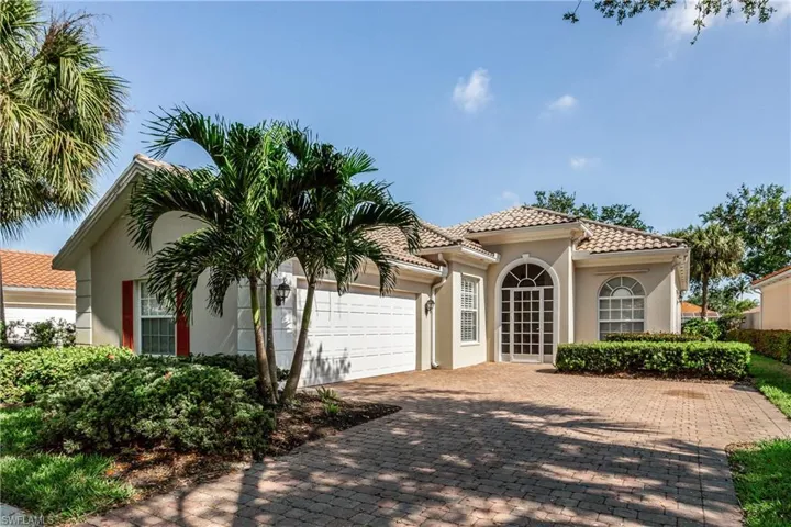 Mediterranean / spanish-style house featuring a tiled roof, a garage, driveway, and stucco siding