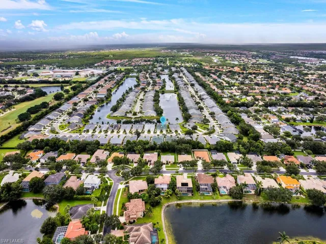 Aerial overview of property's location featuring a large body of water and nearby suburban area